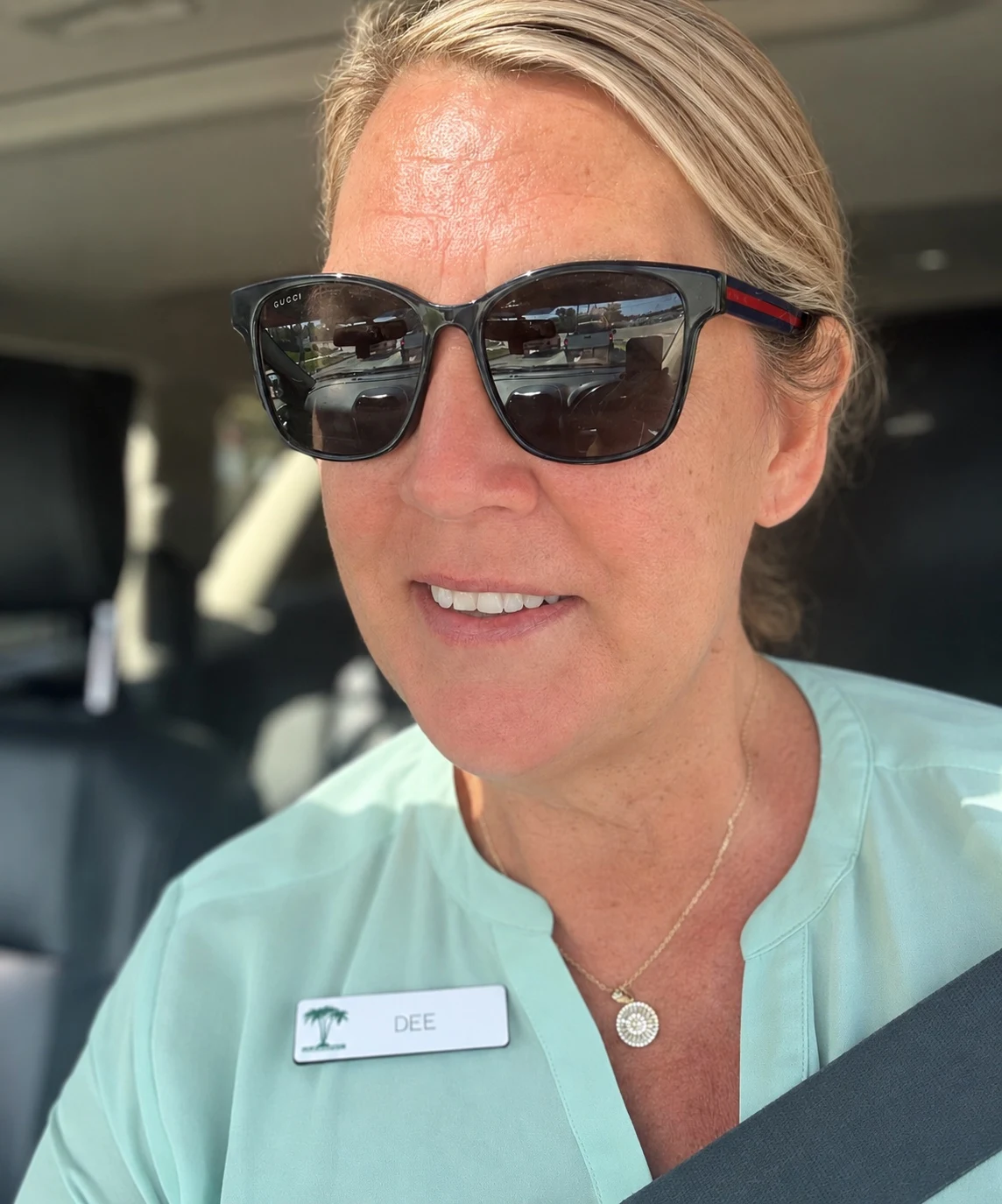 Dee, Mrs. Smash, wearing sunglasses and a seafoam blouse